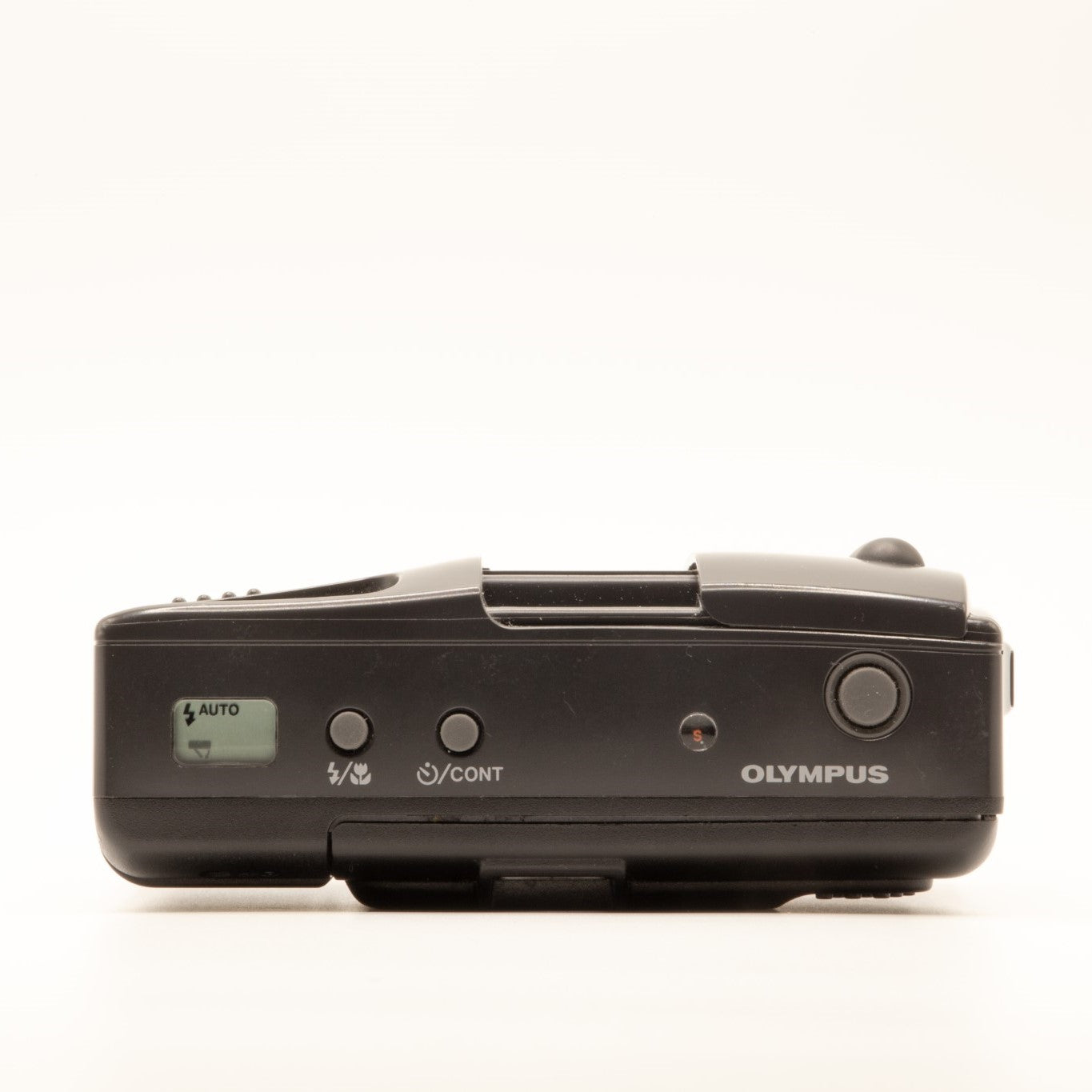 Top plate of the Olympus AF-1 Super 35mm film camera showing shutter button and dials