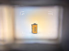 Contax T2 (Titanium) viewfinder, showing the clarity and sharpness of it, highlighting slight stain in the viewfinder. Subject is a roll of Kodak Ultramax 400