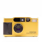 A vintage Contax T2 film camera in metallic gold with a black grip and black lens ring, featuring Carl Zeiss Sonnar 2.8/38mm lenses, shown on a plain white background.