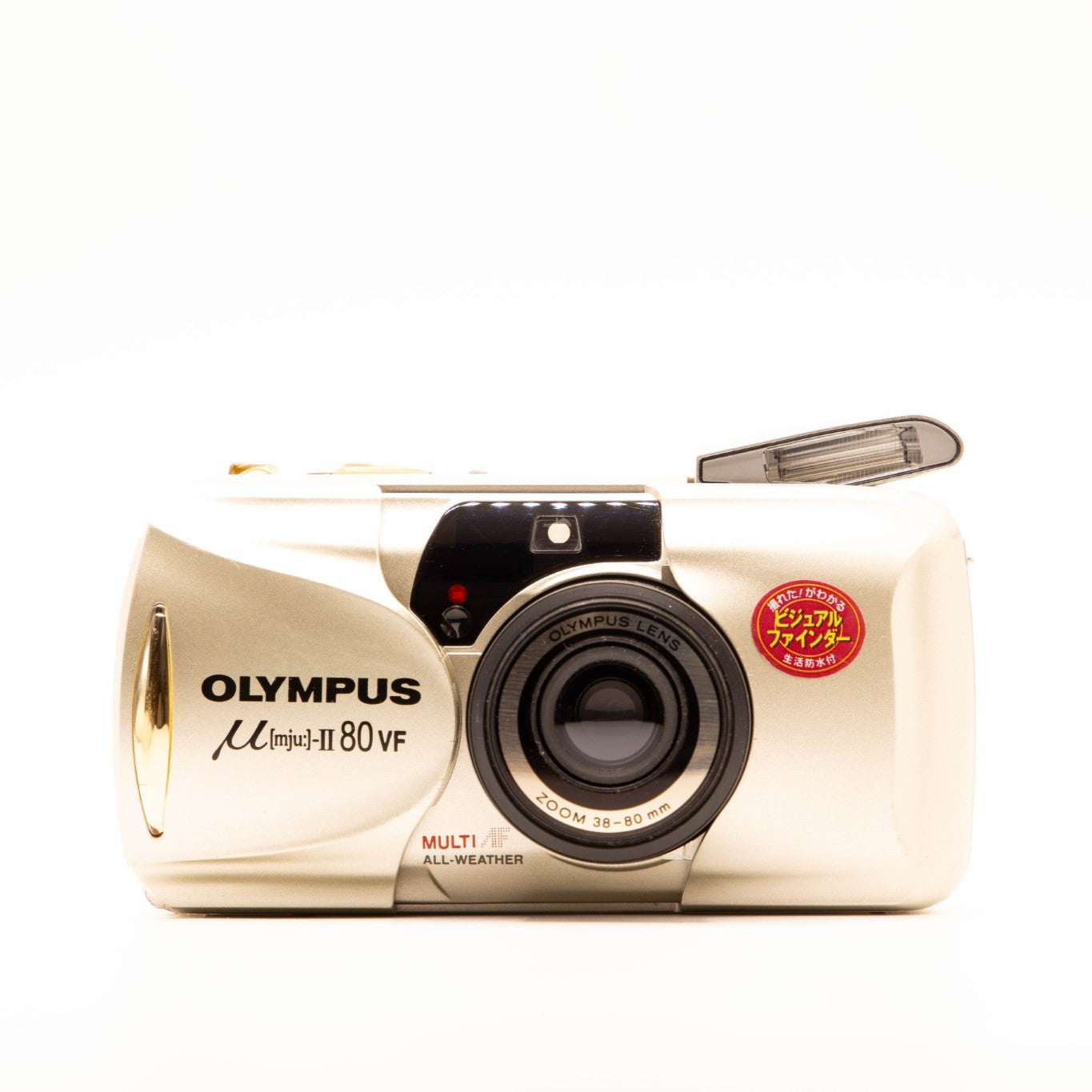 a photo of a vintage olympus gold point-and-shoot film camera
