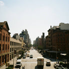 New York city street with brick buildings and vehicles on a sunny day